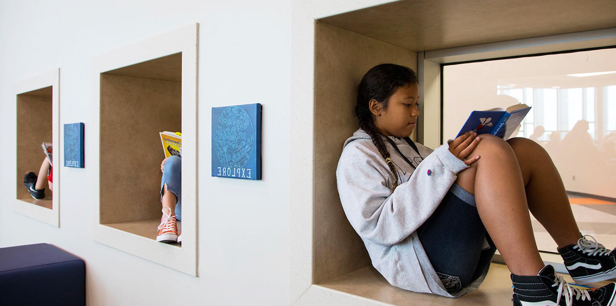 Students reading inside library inside Jim and Pam Wells Elementary School in Cypress